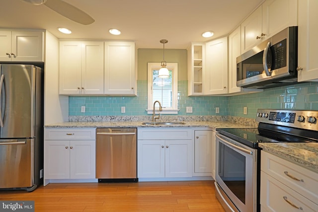 kitchen featuring stainless steel appliances, white cabinets, and sink