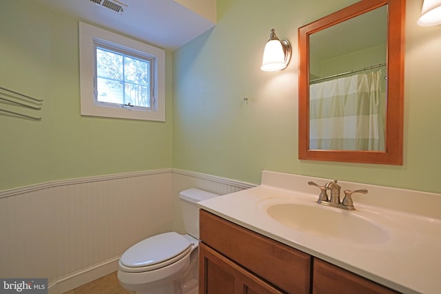 bathroom with vanity and toilet