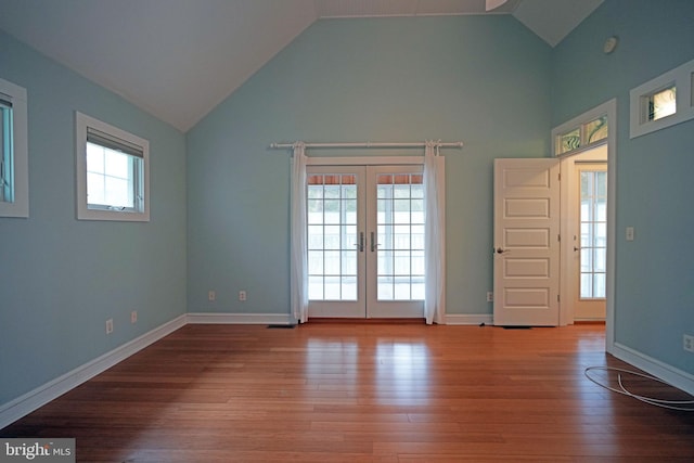 interior space featuring wood-type flooring, french doors, and high vaulted ceiling