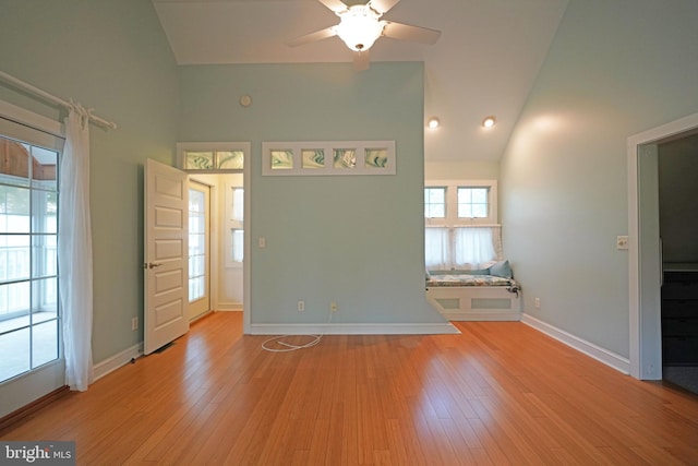 entryway featuring high vaulted ceiling, light wood-type flooring, and ceiling fan