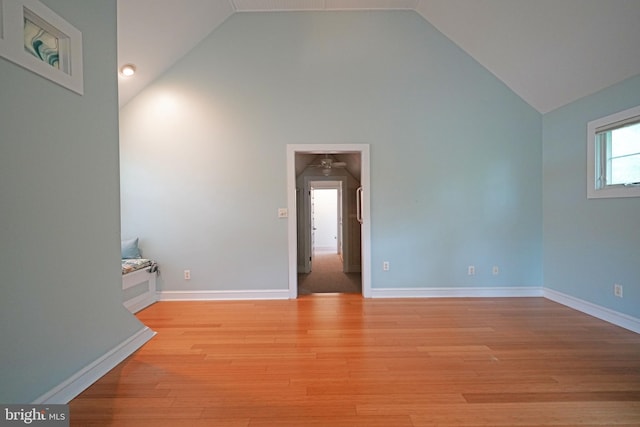 empty room featuring light hardwood / wood-style flooring and vaulted ceiling