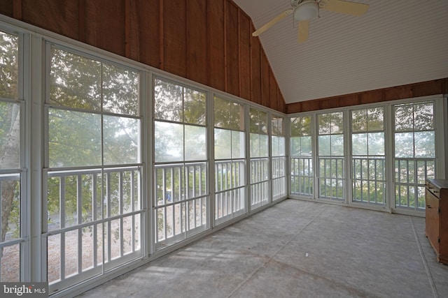 unfurnished sunroom with ceiling fan, lofted ceiling, and plenty of natural light