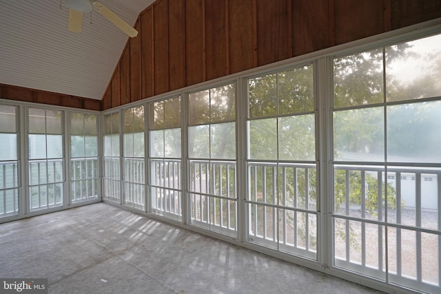 unfurnished sunroom with vaulted ceiling, ceiling fan, and plenty of natural light