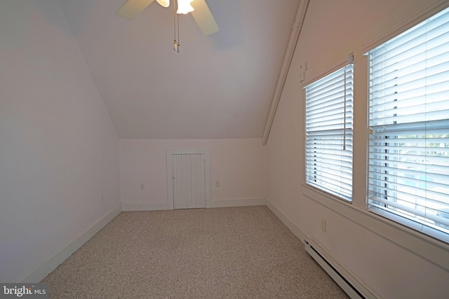 additional living space with light carpet, lofted ceiling, ceiling fan, and baseboard heating