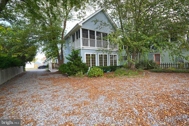 rear view of house featuring a sunroom