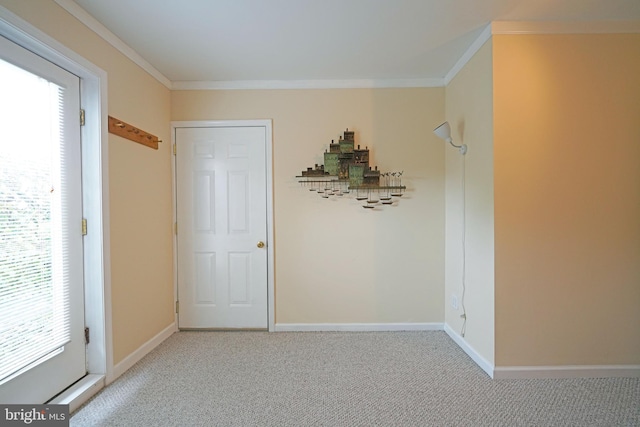 hall featuring light colored carpet, a healthy amount of sunlight, and crown molding