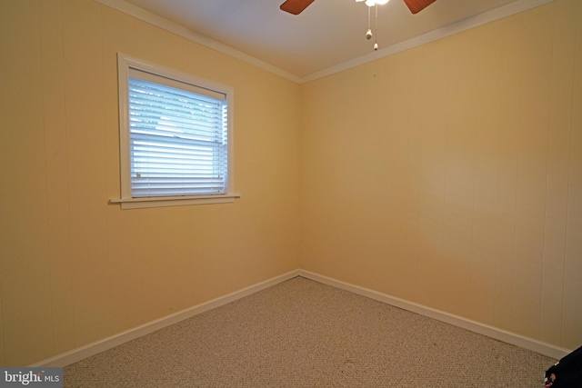 empty room featuring carpet floors, ornamental molding, and ceiling fan