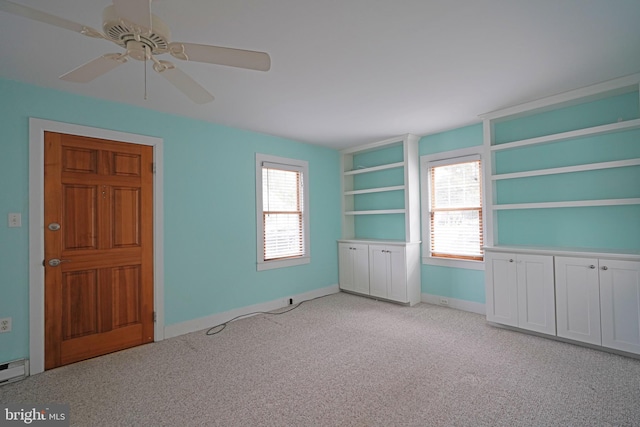 carpeted spare room with ceiling fan and a healthy amount of sunlight