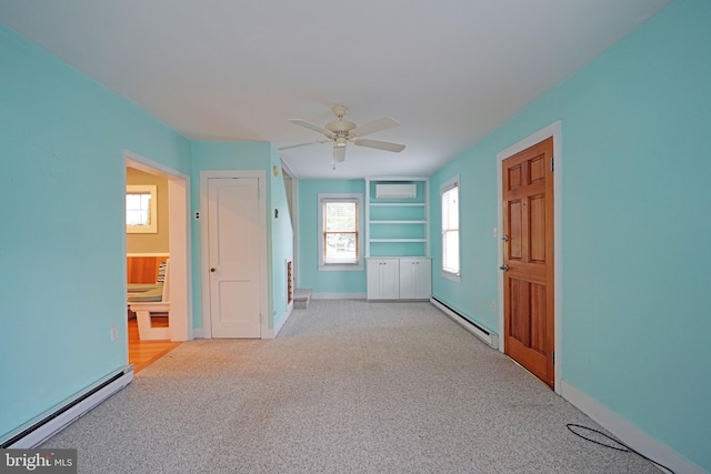 interior space featuring ceiling fan, baseboard heating, and light carpet