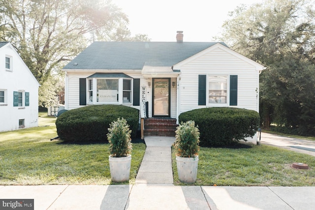 bungalow-style home with a front yard