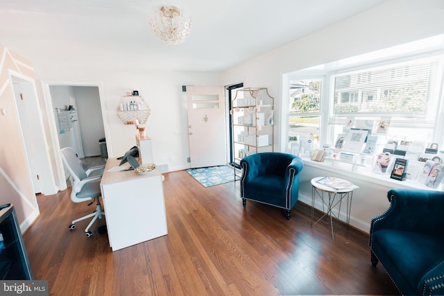 office featuring dark hardwood / wood-style flooring and an inviting chandelier