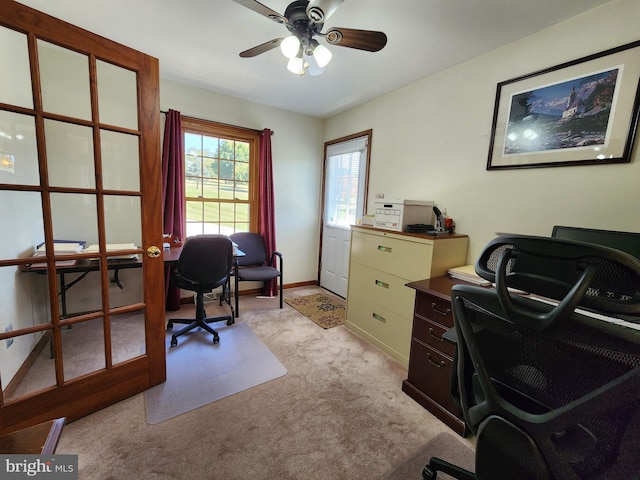 home office featuring light carpet and ceiling fan