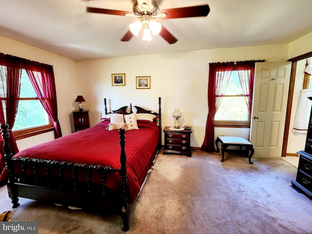 bedroom featuring carpet flooring, multiple windows, and ceiling fan