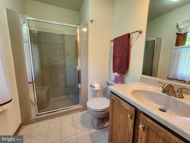 bathroom featuring toilet, vanity, tile patterned floors, and an enclosed shower