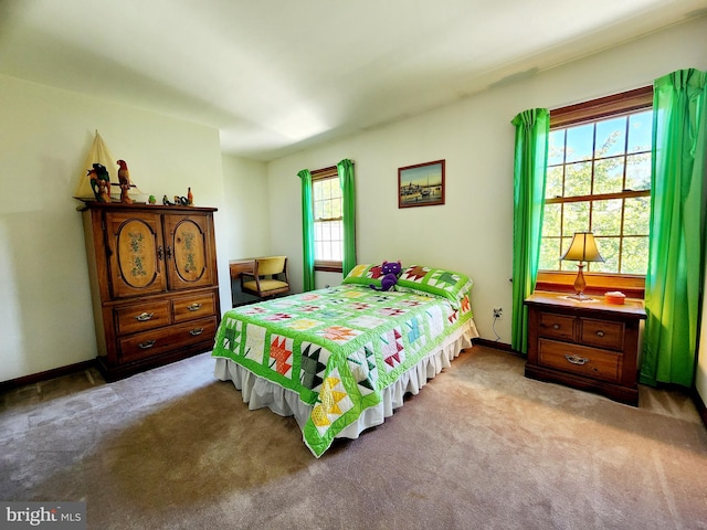 bedroom featuring light carpet and multiple windows