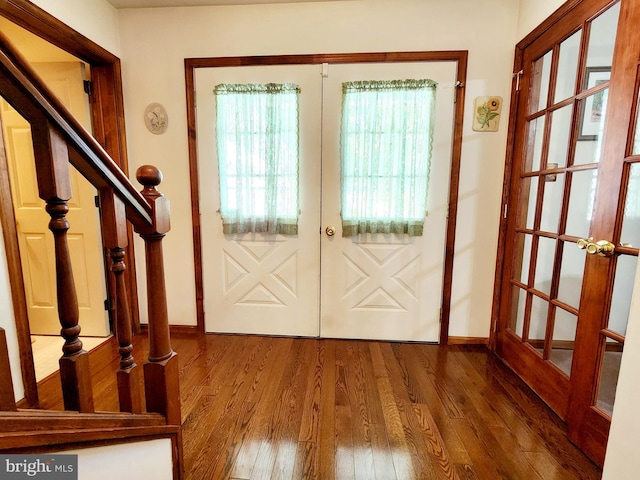 entryway with wood-type flooring and french doors