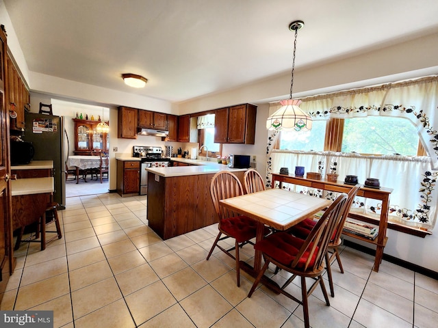 dining area featuring light tile patterned flooring and sink