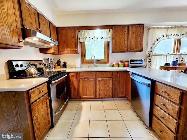 kitchen featuring sink, light tile patterned floors, and stainless steel appliances