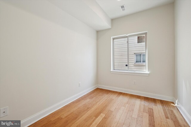 empty room with light hardwood / wood-style flooring