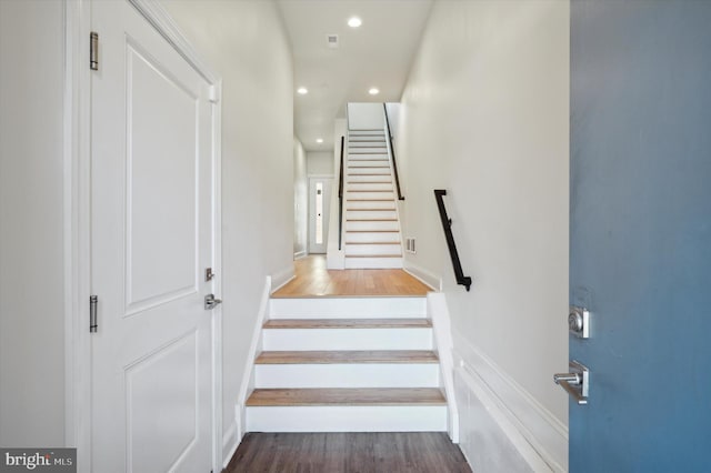 stairs with hardwood / wood-style flooring