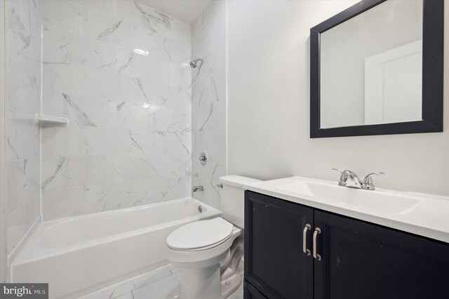 full bathroom featuring tiled shower / bath, toilet, and vanity