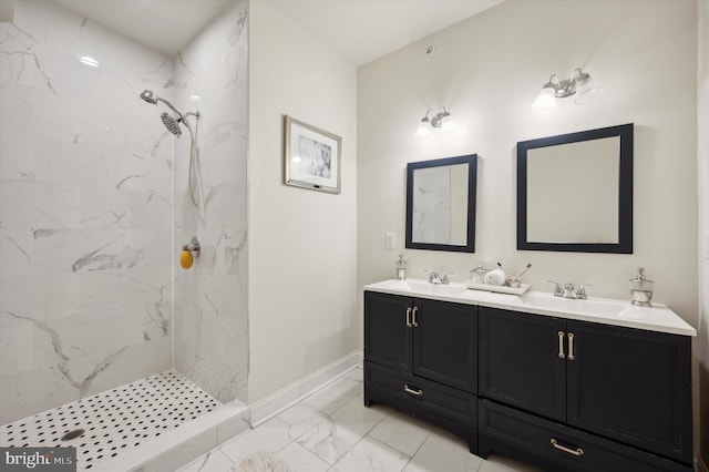 bathroom with vanity and a tile shower