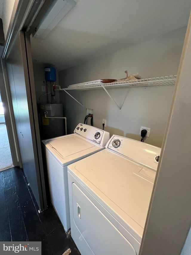 washroom with washing machine and dryer and electric water heater