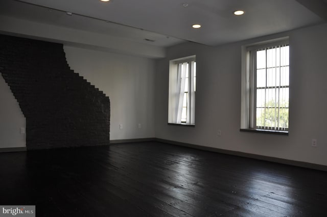 empty room with dark hardwood / wood-style flooring