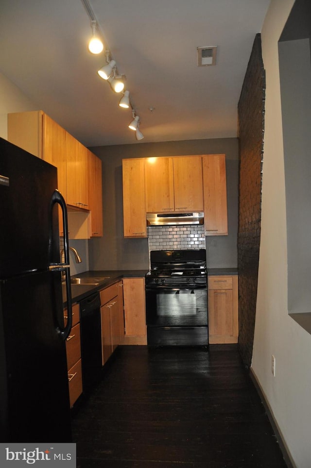 kitchen with light brown cabinetry, sink, black appliances, dark hardwood / wood-style floors, and rail lighting