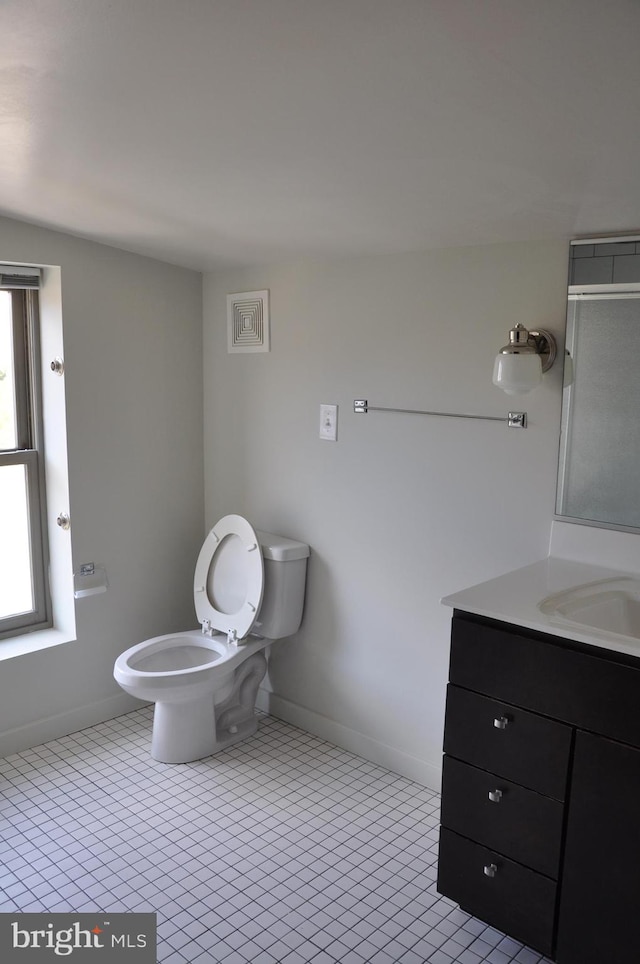 bathroom with tile patterned floors, toilet, and vanity