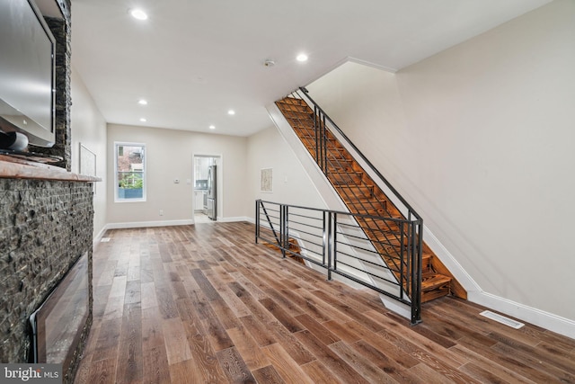 unfurnished living room featuring dark hardwood / wood-style flooring