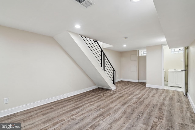 basement with hardwood / wood-style floors