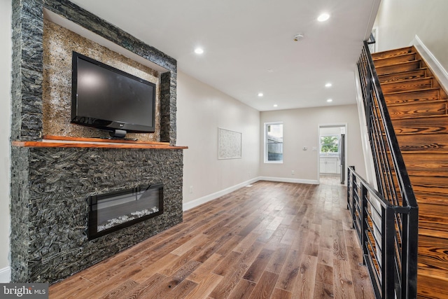 unfurnished living room featuring hardwood / wood-style floors and a fireplace