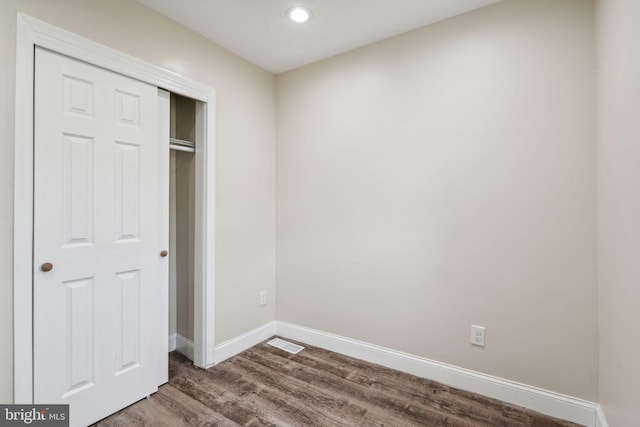 unfurnished bedroom featuring hardwood / wood-style flooring