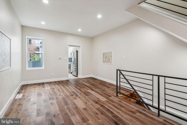 additional living space with hardwood / wood-style floors