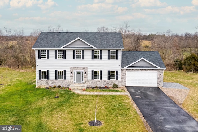 view of front of house featuring a garage and a front lawn