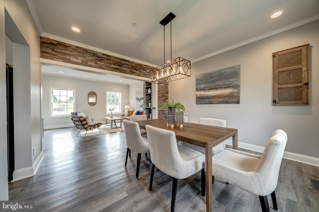 dining space with dark wood-style floors, baseboards, and crown molding