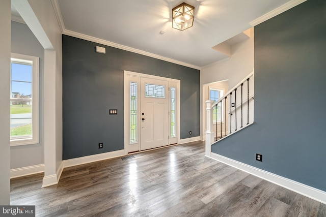 foyer featuring crown molding and hardwood / wood-style flooring