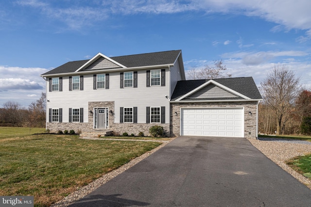 colonial home with a garage, stone siding, aphalt driveway, and a front yard