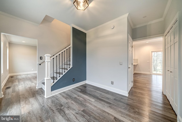 unfurnished room featuring ornamental molding and dark hardwood / wood-style floors