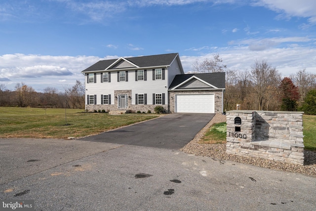 view of front of home with an attached garage, stone siding, aphalt driveway, and a front lawn