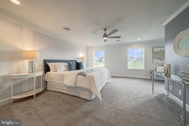 carpeted bedroom with ornamental molding, a ceiling fan, visible vents, and baseboards