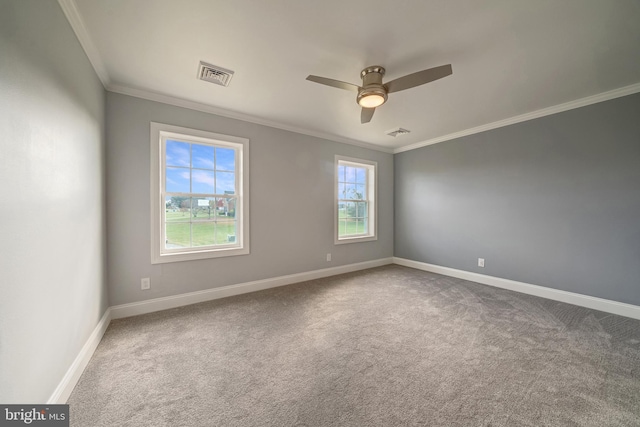 unfurnished room featuring baseboards, visible vents, crown molding, and carpet flooring