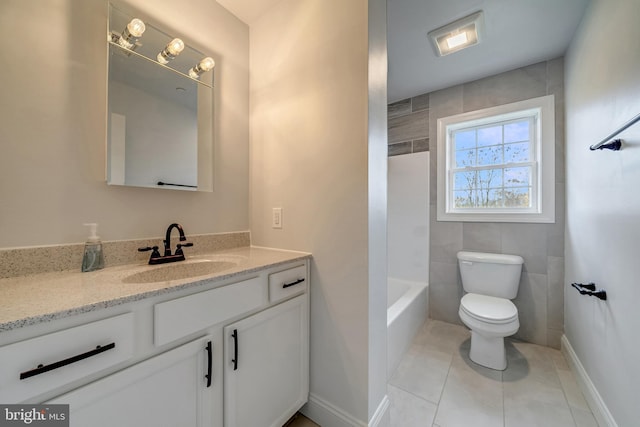 bathroom with toilet, tile patterned flooring, baseboards, and vanity