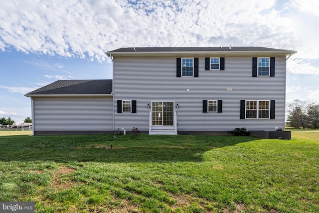 back of house with a lawn