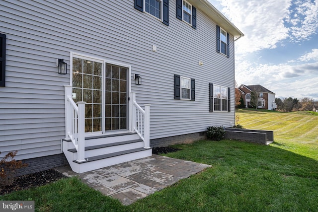 exterior space featuring crawl space and a lawn