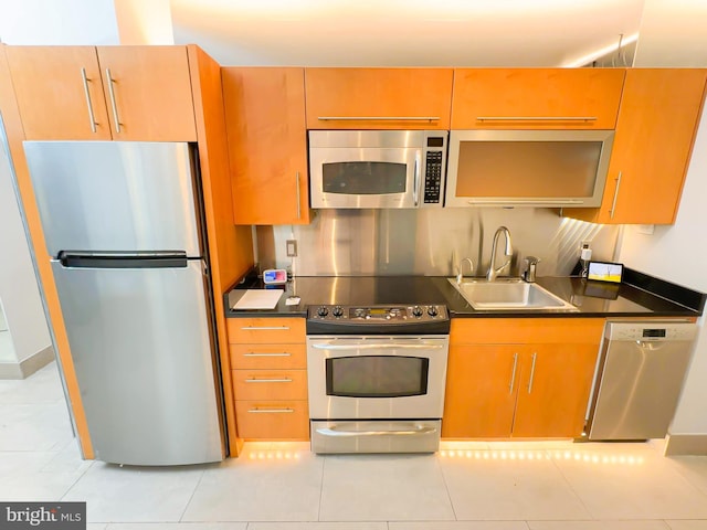 kitchen featuring stainless steel appliances, light tile patterned floors, and sink