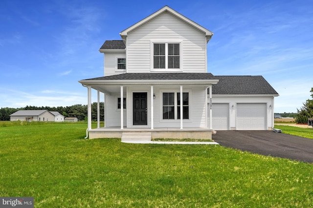 view of front of property with a garage, a front yard, and covered porch