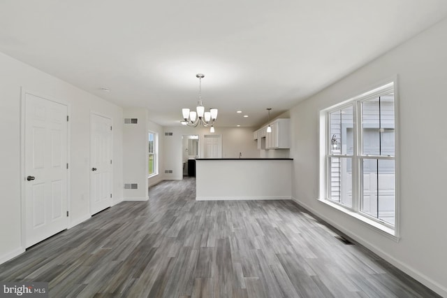 interior space with dark hardwood / wood-style floors and a notable chandelier