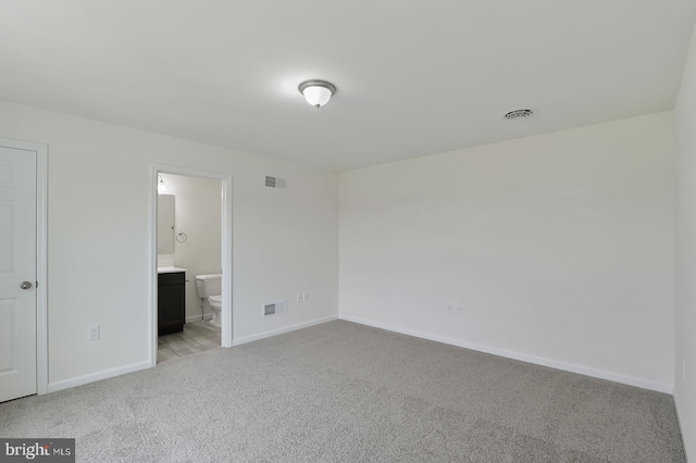 unfurnished bedroom with baseboards, visible vents, and light colored carpet